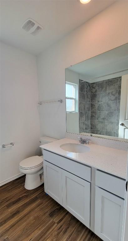 5605 Bellissima Way, Round Rock, TX 78665 - full bath with wood finished floors, vanity, and toilet