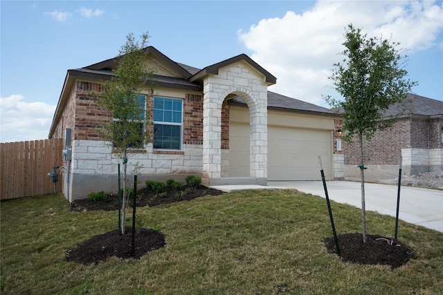 5605 Bellissima Way, Round Rock, TX 78665 - view of front of home featuring an attached garage, concrete driveway, brick siding, and stone siding