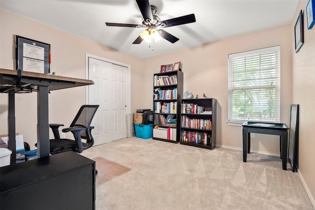 office space with a ceiling fan, carpet flooring, and baseboards