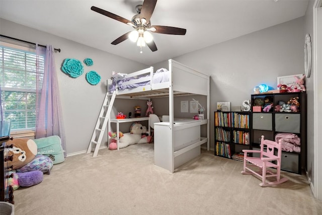 carpeted bedroom with multiple windows and ceiling fan