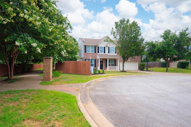 traditional home with asphalt driveway, a garage, and brick siding