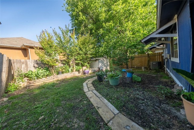 view of yard with an outdoor structure, a storage shed, and central AC unit