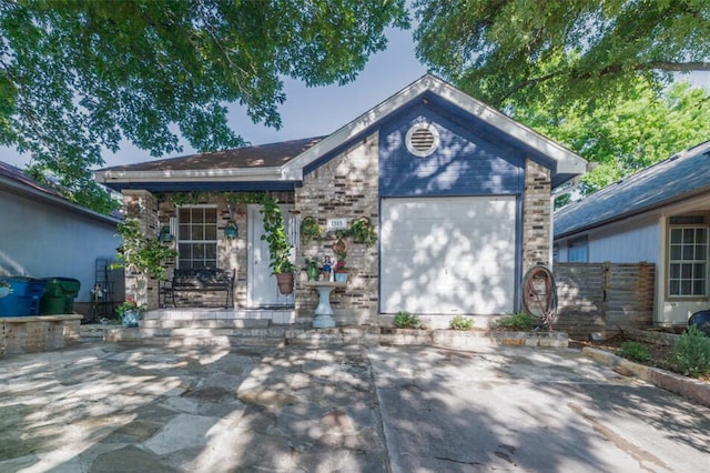 ranch-style home with a garage and fence