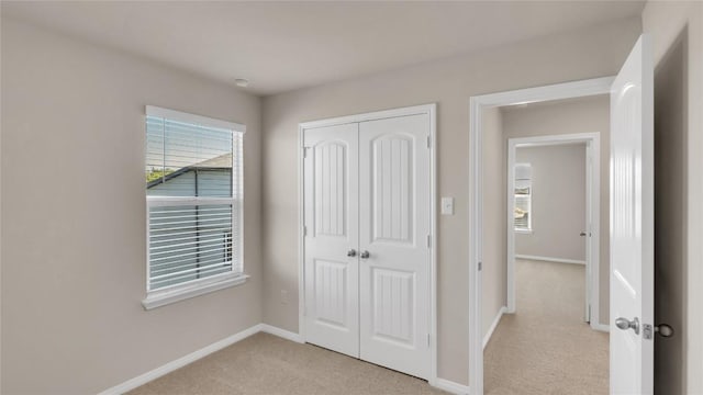 204 Inks Ln, Kyle, TX 78640 - unfurnished bedroom with light carpet, a closet, and baseboards