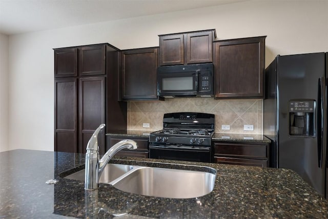 kitchen with black appliances, a sink, dark brown cabinets, tasteful backsplash, and dark stone counters