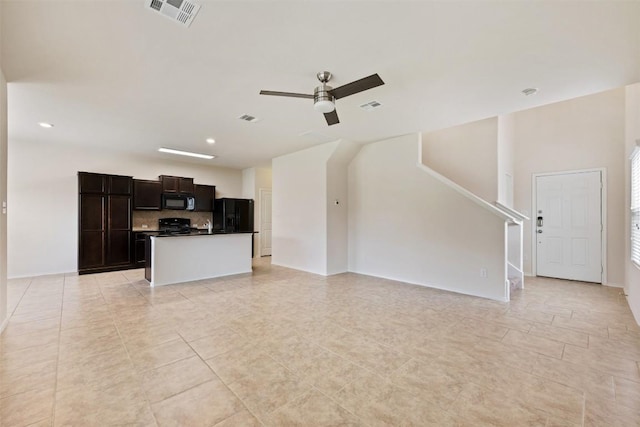 unfurnished living room featuring ceiling fan, light tile patterned floors, recessed lighting, and stairway
