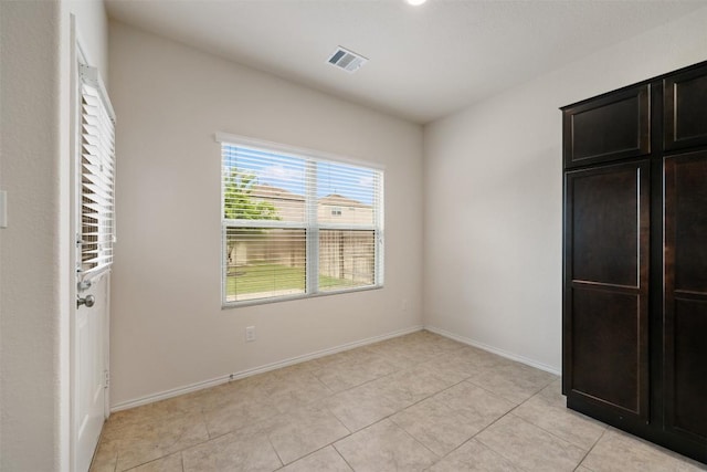 unfurnished bedroom with baseboards and light tile patterned floors