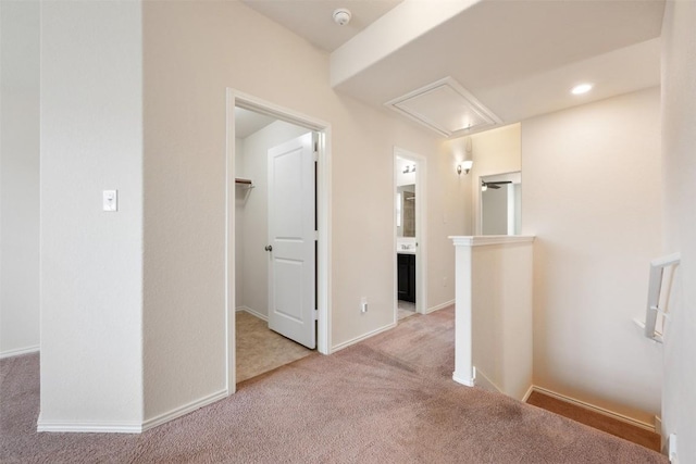 3548 Pauling Loop, Round Rock, TX 78665 - hall featuring attic access, carpet flooring, an upstairs landing, and baseboards