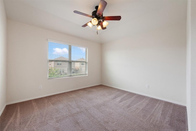 empty room featuring carpet floors, a ceiling fan, and baseboards