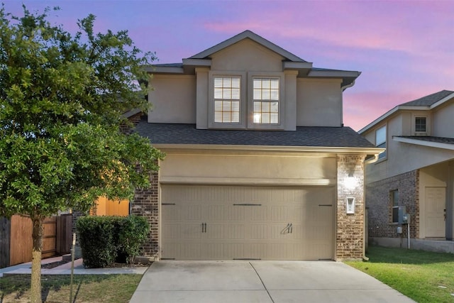 3548 Pauling Loop, Round Rock, TX 78665 - view of front facade featuring driveway, stucco siding, a shingled roof, and stone siding
