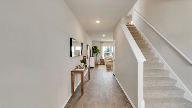 154 Sandringham Loop, Uhland, TX 78640 - hall featuring stairway, wood finished floors, recessed lighting, and baseboards