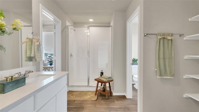 154 Sandringham Loop, Uhland, TX 78640 - full bathroom with a shower stall, wood finished floors, vanity, baseboards, and recessed lighting