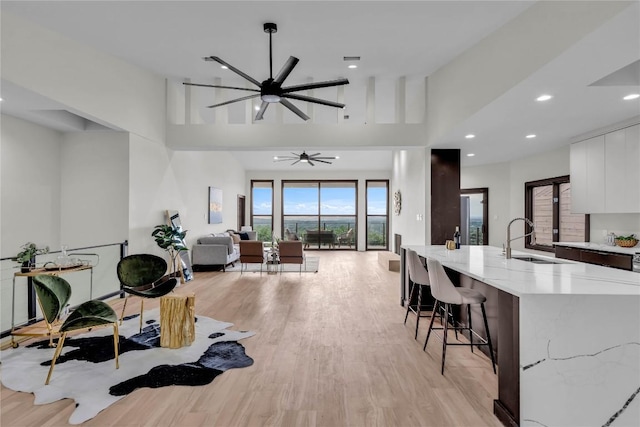 112 Paragon Ct, Lakeway, TX 78734 - living room featuring light wood-style flooring, ceiling fan, recessed lighting, and a high ceiling
