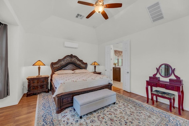 bedroom featuring wood finished floors, a wall unit AC, vaulted ceiling, and a ceiling fan
