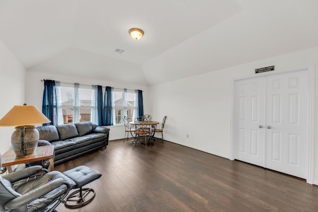 living room featuring vaulted ceiling and wood finished floors