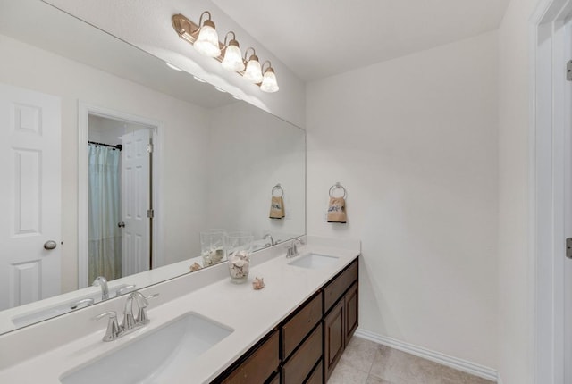 bathroom featuring baseboards, double vanity, tile patterned flooring, and a shower with curtain