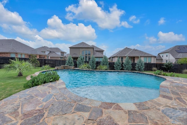 view of swimming pool with a fenced backyard, a residential view, and a patio area