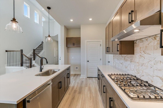 1401 S Brook Dr, Leander, TX 78641 - kitchen with stainless steel appliances, exhaust hood, light wood-type flooring, light countertops, and recessed lighting