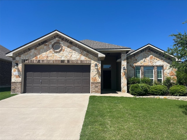 7224 Abalone Way, Temple, TX 76502 - view of front facade with an attached garage, driveway, stone siding, and a front lawn