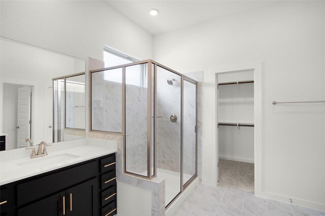 204 Ridgewell Loop, Georgetown, TX 78633 - full bathroom with vanity, a shower stall, a walk in closet, baseboards, and marble finish flooring