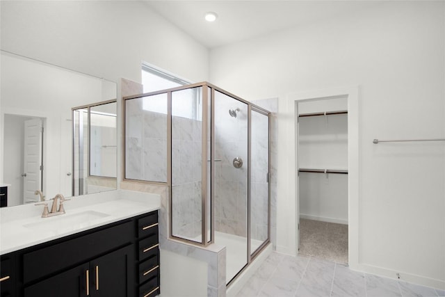 204 Ridgewell Loop, Georgetown, TX 78633 - bathroom featuring vanity, a shower stall, a walk in closet, and marble finish flooring
