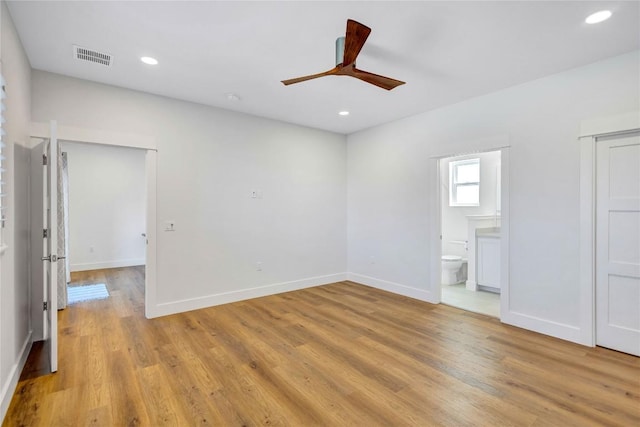 unfurnished bedroom with light wood-style floors, baseboards, recessed lighting, ensuite bathroom, and a ceiling fan