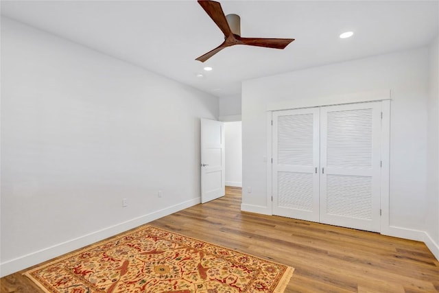 unfurnished bedroom with light wood-type flooring, recessed lighting, baseboards, a closet, and ceiling fan