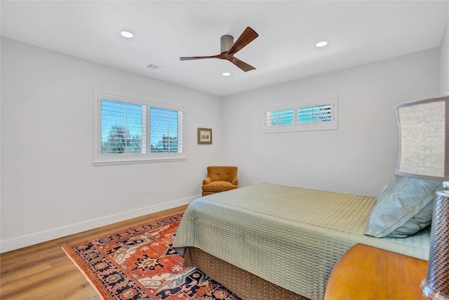 bedroom with wood finished floors, baseboards, recessed lighting, and a ceiling fan