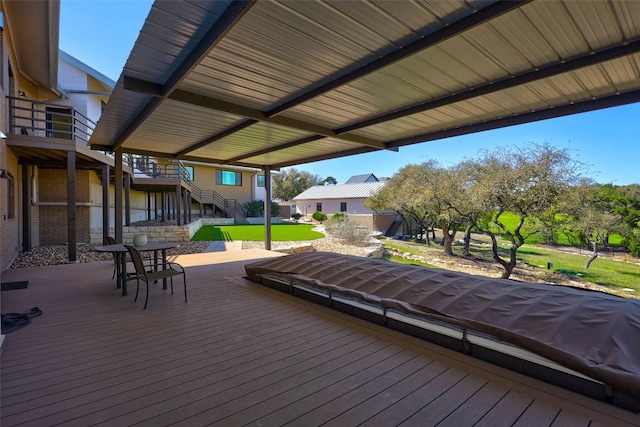 wooden terrace featuring stairway and a lawn