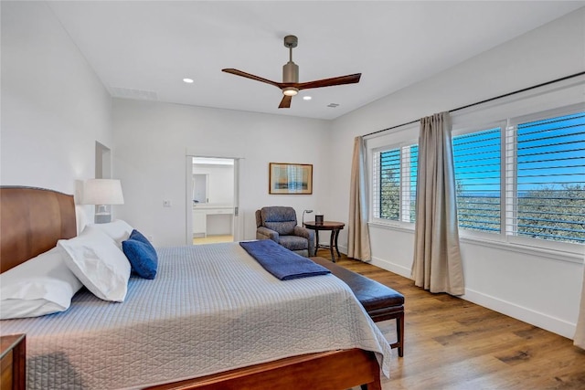 bedroom featuring wood finished floors, baseboards, a ceiling fan, recessed lighting, and ensuite bathroom