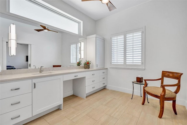 bathroom featuring a ceiling fan, vanity, and baseboards