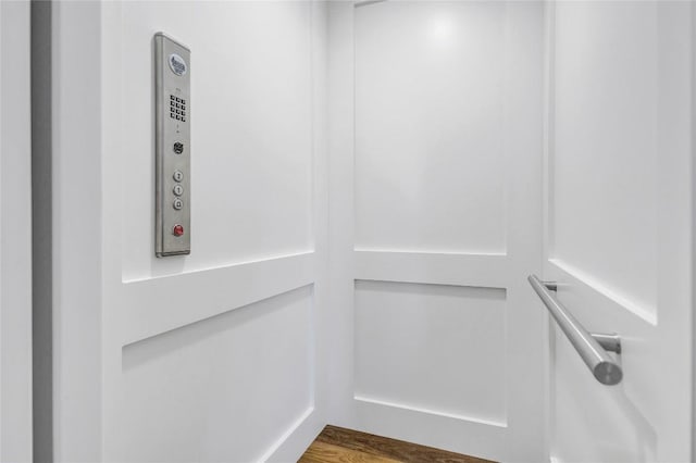 elevator featuring wood finished floors