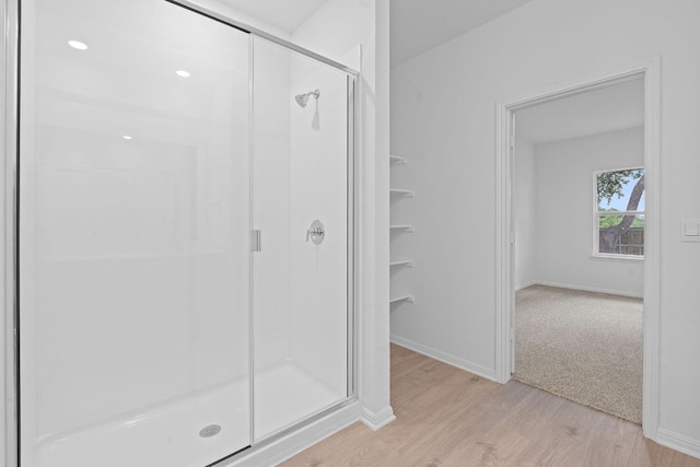 2416 Cattle Baron Trl, Leander, TX 78641 - full bath featuring wood finished floors, a stall shower, and baseboards