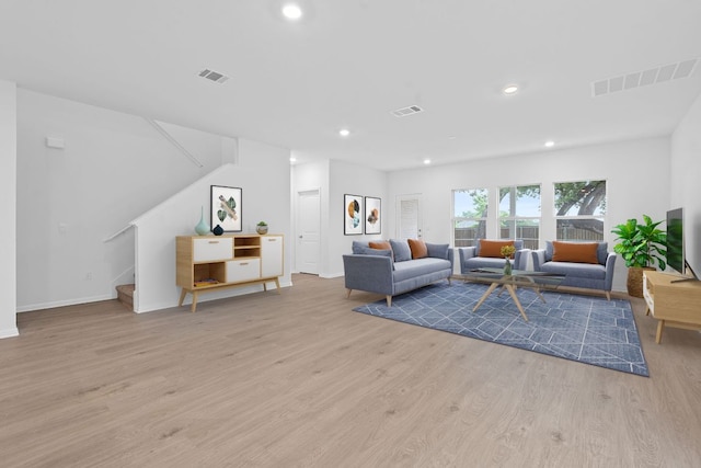 2416 Cattle Baron Trl, Leander, TX 78641 - living room featuring wood finished floors, stairs, recessed lighting, and baseboards
