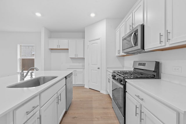 2416 Cattle Baron Trl, Leander, TX 78641 - kitchen featuring stainless steel appliances, a sink, recessed lighting, and white cabinets