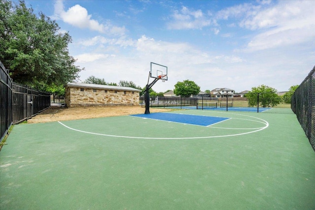 view of sport court with community basketball court, fence, and a tennis court