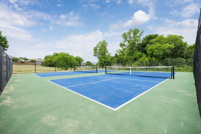 view of tennis court with fence