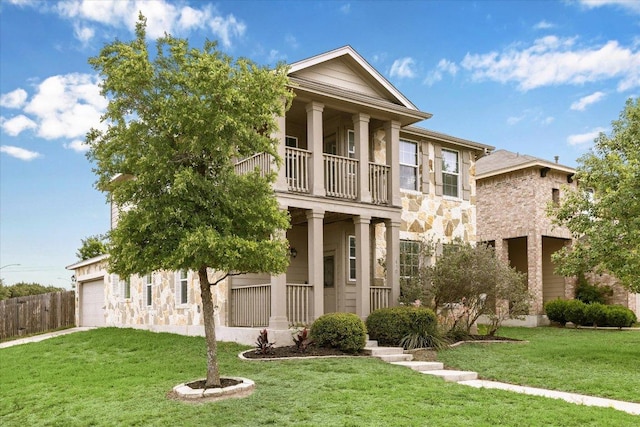greek revival inspired property featuring a balcony, stone siding, an attached garage, and a porch