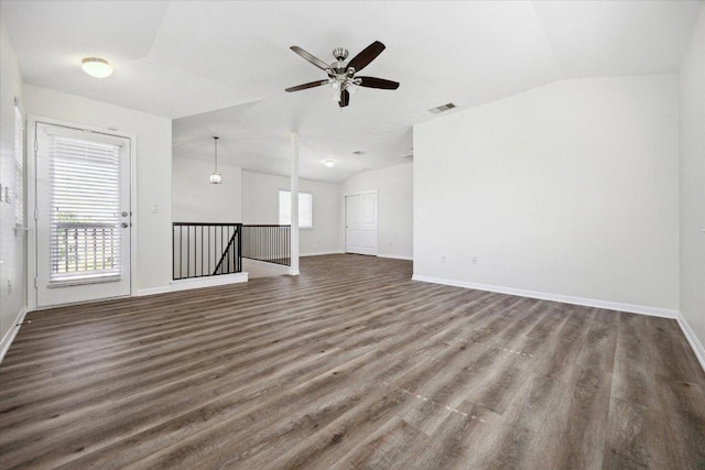 unfurnished living room featuring vaulted ceiling, wood finished floors, baseboards, and ceiling fan