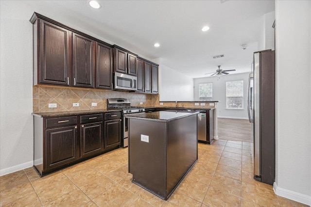 kitchen featuring stainless steel appliances, baseboards, tasteful backsplash, and recessed lighting