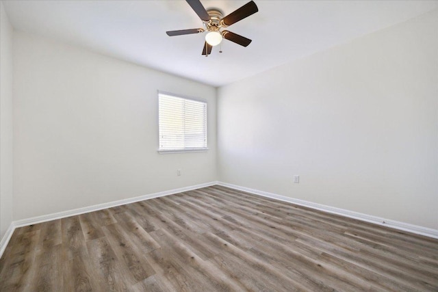 unfurnished room featuring wood finished floors, baseboards, and ceiling fan
