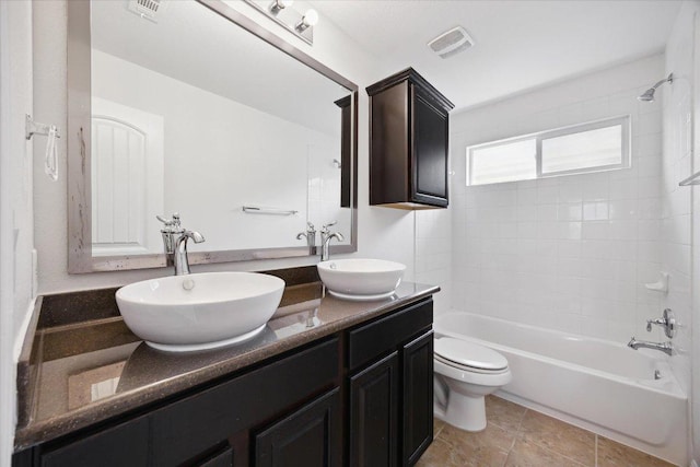 full bathroom with tub / shower combination, toilet, double vanity, and tile patterned flooring