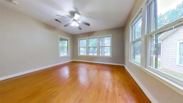 empty room featuring baseboards, light wood-style floors, and a ceiling fan