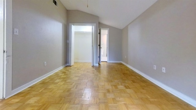 additional living space with baseboards and lofted ceiling