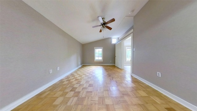 unfurnished room with baseboards, a ceiling fan, and vaulted ceiling
