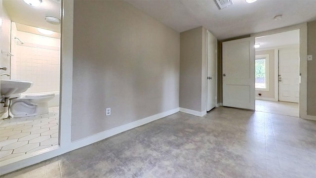 unfurnished room with baseboards