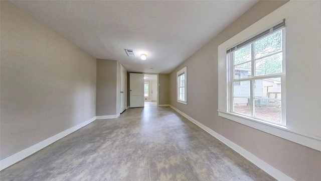 spare room with baseboards