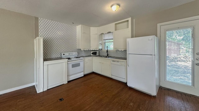 kitchen featuring white appliances, white cabinetry, dark wood-type flooring, tasteful backsplash, and a sink