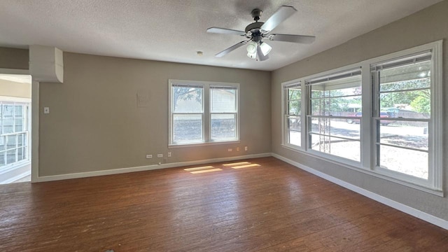 unfurnished room with baseboards, wood finished floors, a textured ceiling, and a ceiling fan