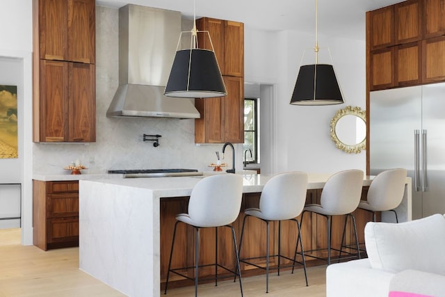4405 Hennig Dr, Austin, TX 78738 - kitchen featuring wall chimney range hood, stainless steel appliances, light countertops, and decorative backsplash